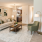 Staged apartment living room with plants and green decor