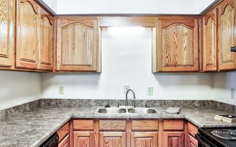 a kitchen with wooden cabinets