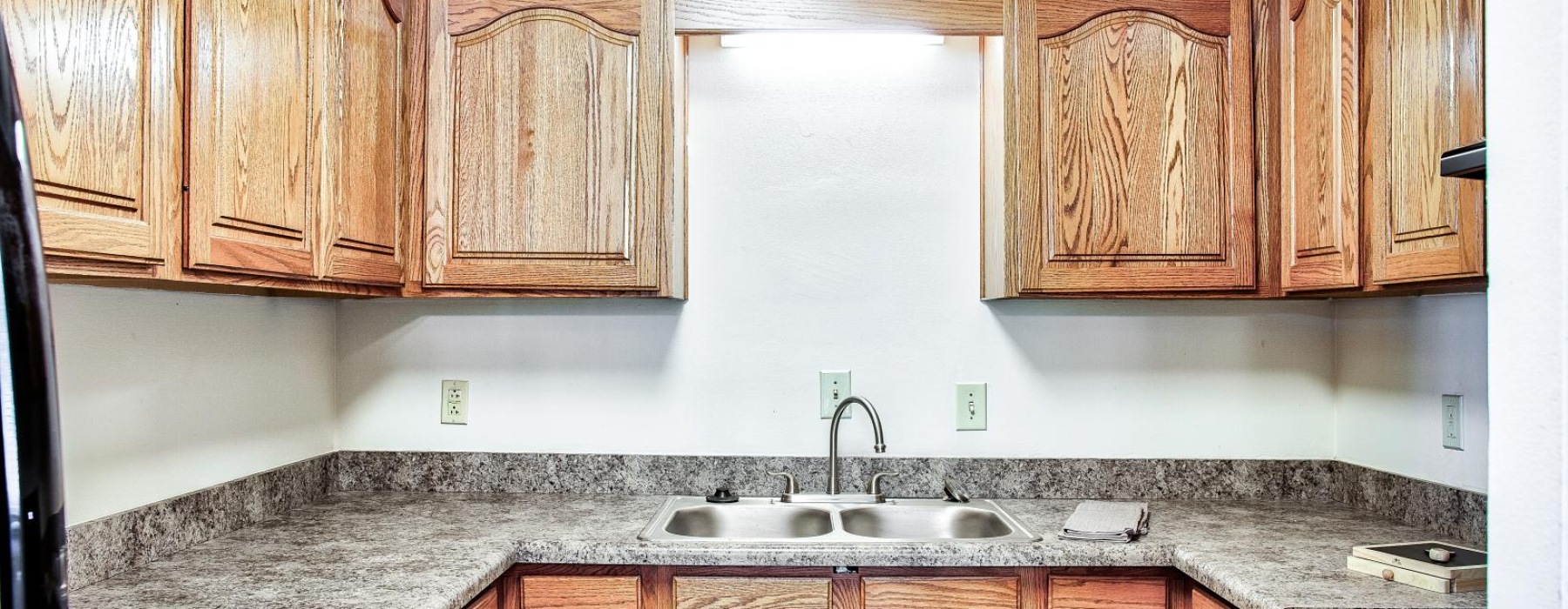 a kitchen with wooden cabinets